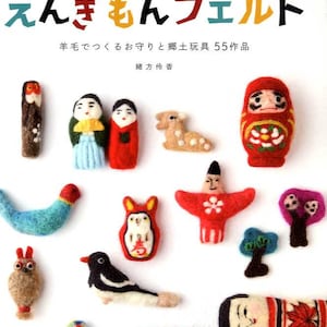 May include: A collection of colorful felt ornaments and toys, including a Daruma doll, owl, bird, and other figures. The Japanese text at the top reads "Engimono Felt". The image showcases various handcrafted items, likely for decoration or as lucky charms.