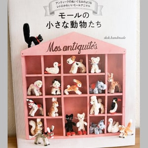 May include: A set of three ceramic mugs with a speckled, matte finish in cream, light grey, and dark grey. Each mug features a simple, minimalist design, ideal for coffee or tea.