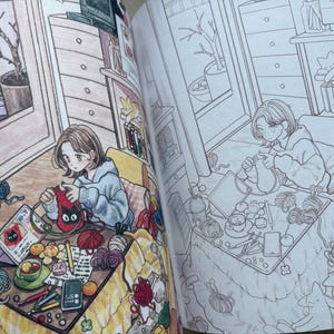 May include: A colouring book page featuring a detailed illustration of a person knitting at a table. The scene includes yarn balls, a tablet displaying a cat graphic, a cup, pencils, and a cat resting nearby, shown in both coloured and line art versions.