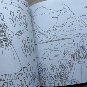May include: A coloring book spread featuring two detailed illustrations. One shows a person in traditional Dutch attire holding flowers, surrounded by tulips. The other depicts a person looking at a mountain landscape with flowers.