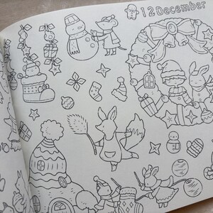 May include: A black and white illustration from a colouring book with a Christmas theme. The page includes a wreath, a snowman, a fox, and the text "12 December". Other elements include stars, gifts, and holiday characters.