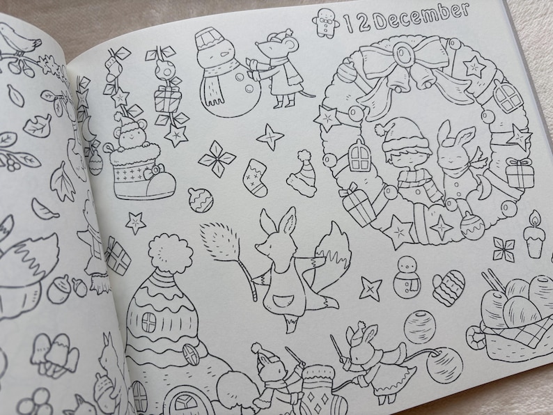 May include: A black and white illustration from a colouring book with a Christmas theme. The page includes a wreath, a snowman, a fox, and the text "12 December". Other elements include stars, gifts, and holiday characters.