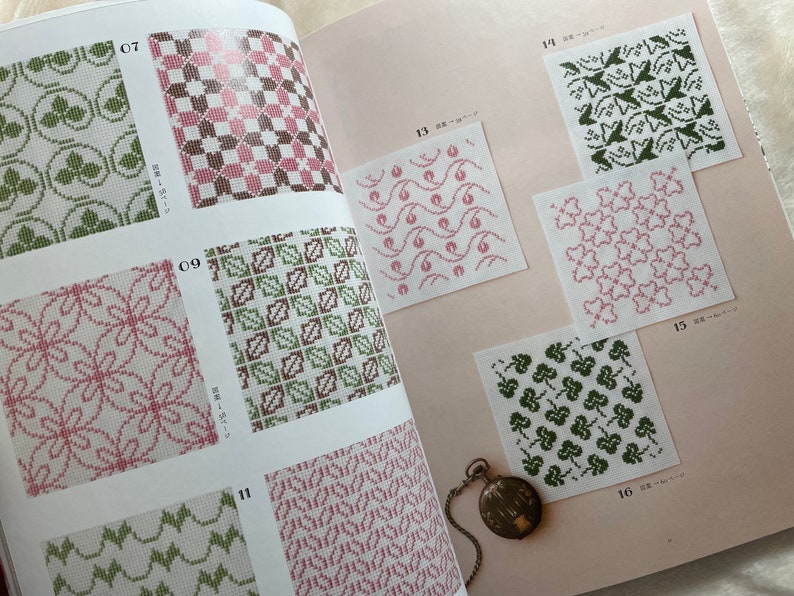 May include: A book with pages showing different embroidery patterns. The patterns are in shades of green, pink, and brown. The numbers 07, 09, 11, 13, 14, 15, and 16 are visible on the pages.