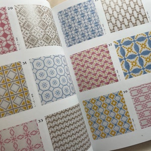 May include: A book with a variety of colorful geometric patterns. The patterns are numbered 29, 31, 33, 35, 37, 39, and 40. The book is open to pages 31 and 37.