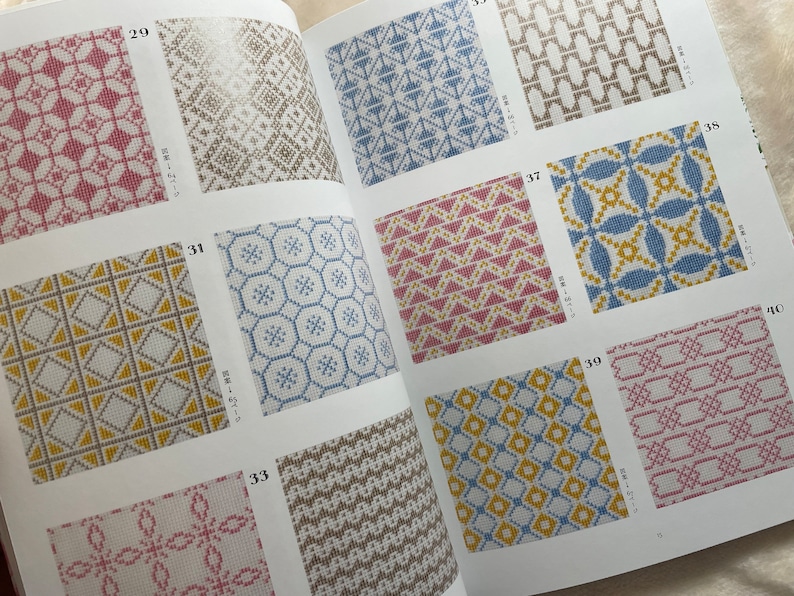 May include: A book with a variety of colorful geometric patterns. The patterns are numbered 29, 31, 33, 35, 37, 39, and 40. The book is open to pages 31 and 37.