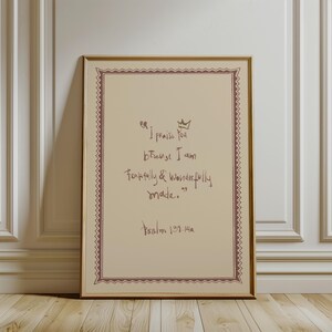 May include: A framed print with a beige background and a decorative border. The print features handwritten text in brown ink, including the quote "I praise You because I am fearfully & wonderfully made." and the reference "Psalm 139:14a."