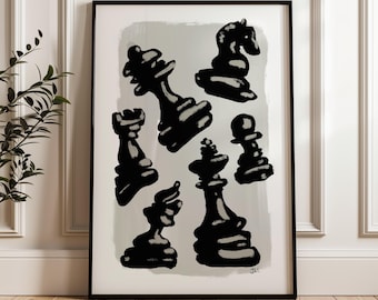 May include: Black and white abstract art print featuring various chess pieces. The pieces are depicted in a bold, brushstroke style against a light gray background. The artwork is framed in a black frame and displayed on a wooden floor.