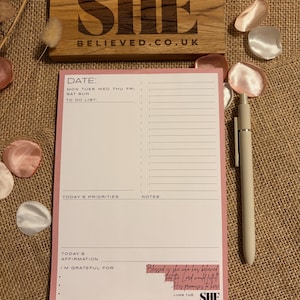 May include: A distressed wooden sign, reading "Welcome to our home" in white lettering. The sign has a rustic finish, ideal for a porch or hallway, creating a welcoming atmosphere.