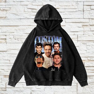 May include: Black hooded sweatshirt with a vintage-style graphic print of a band. The print features five men with the text "CUSTOM" and "Text" above them.