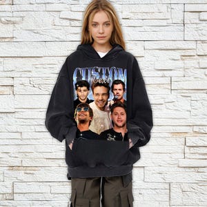 May include: Black hooded sweatshirt with a vintage-style graphic print of five men's faces. The print includes the text "CUSTOM Text".