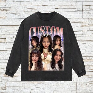 May include: Black long-sleeved shirt with a graphic print of five women's faces and the text "CUSTOM Text" in pink and purple lettering.