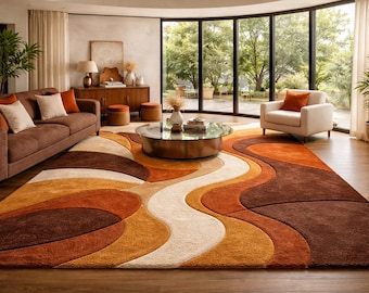 May include: A living room featuring a brown sofa with orange and cream pillows, a white armchair, and a large area rug with a wavy pattern in shades of brown, orange, and cream. A glass-topped coffee table sits in the center.