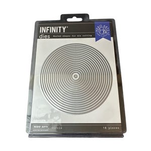 May include: A set of 18 silver metal circular nesting dies for die cutting, packaged in a black and white Hero Arts Infinity brand card. The packaging features the text Infinity dies, nested shapes for die cutting, and Circle 18 pieces.
