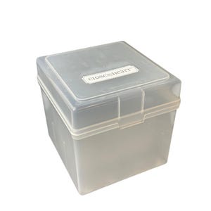 May include: A square, semi-transparent plastic storage box with a hinged lid. The lid features a white rectangular label with the text Close To My Heart printed in black. The container has a clear, smooth finish and a secure latch mechanism.