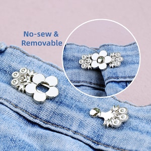 May include: Silver-colored, no-sew and removable flower-shaped button fasteners. The image shows the fasteners attached to denim fabric. The text in the image reads "No-sew & Removable".