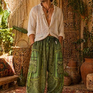 May include: A beige long-sleeved button-down shirt with a textured finish paired with loose-fitting olive green cargo trousers featuring a mottled wash, large side pockets with vertical striped panels, spiral embroidery, and an elasticated drawstring waist.