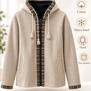May include: A beige herringbone patterned zip-up hoodie with a black fleece lining. The garment features a decorative trim with geometric patterns along the zip and hood, two side pockets, and drawstring cords with tassel ends. Text includes Cotton, Fleece-lined, Hood, and Two pockets.