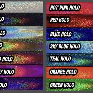 May include: A collection of holographic vinyl sheets in various colors. The colors include white, black, silver, gold, rose gold, raspberry, purple, hot pink, red, blue, sky blue, teal, orange, and green. Each sheet has a shimmering, reflective surface.