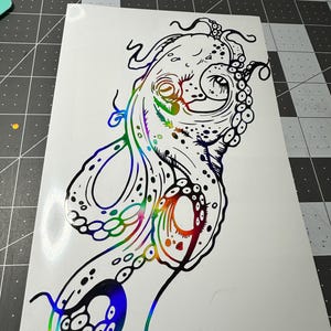 May include: A black and white line drawing of an octopus with iridescent rainbow colors. The octopus is facing to the right and has its tentacles curled around itself.