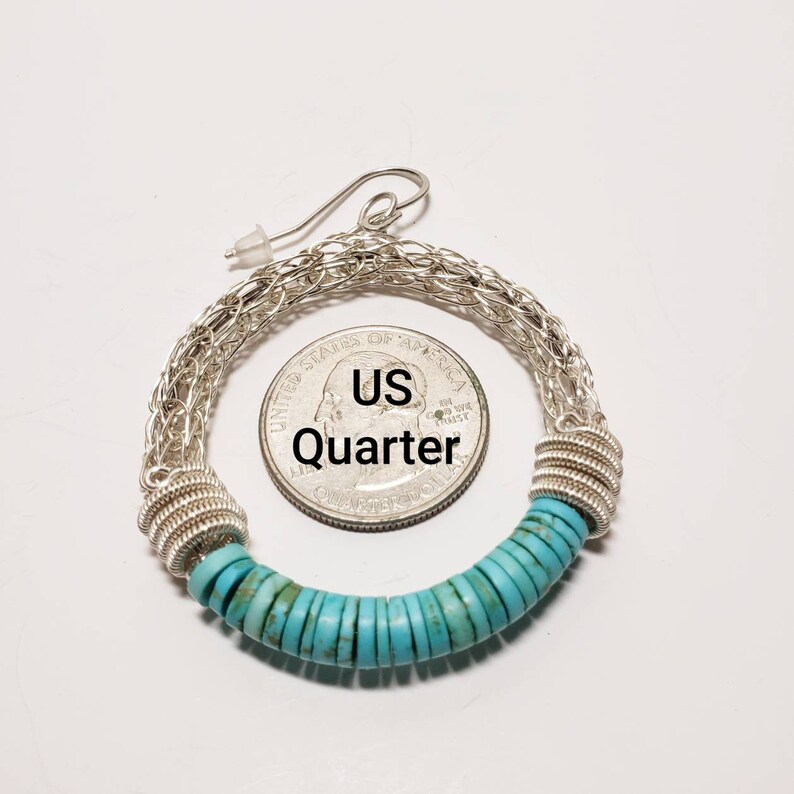 May include: Silver hoop earrings with a turquoise bead accent. The earrings are large enough to fit over a US quarter.