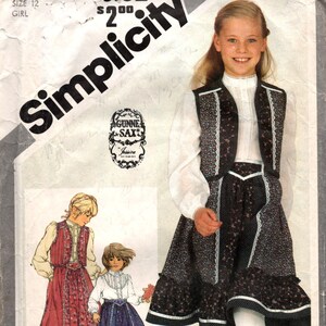 May include: Simplicity sewing pattern for a girl's dress, size 12. The pattern features a floral print dress with a vest and a white blouse. The image includes the text "Simplicity" and "GUNNE SAX Jessica".