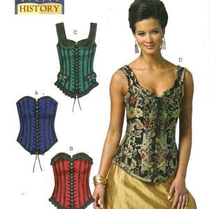 May include: Butterick B5662 sewing pattern for historical corsets. The pattern includes three corset designs in blue, red, and green, with black lacing and trim. The model is wearing a floral corset. The pattern size is (6-8-10-12-14).
