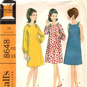 May include: Vintage McCall's sewing pattern 8648 featuring three Misses' dresses. The dresses include a yellow long-sleeve dress, a white dress with red polka dots, and a blue sleeveless dress. The pattern includes the text "DRESSMAKER TESTED" and "MISSES' DRESS IN TWO VERSIONS".