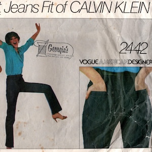 May include: A vintage Vogue American Designer sewing pattern envelope 2442 titled The Exact Jeans Fit of CALVIN KLEIN. The cover features illustrations of dark blue jeans and a skirt, with text including Georgia's and the pattern number 2442.
