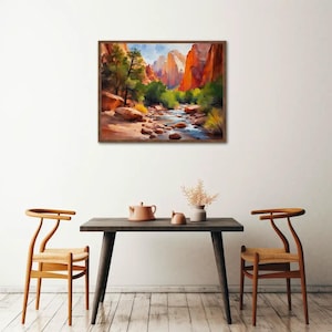May include: A framed watercolor painting depicts a canyon landscape with a river flowing through it. The artwork features red rock formations, green trees, and a blue sky. The painting is displayed above a dark table with two chairs.
