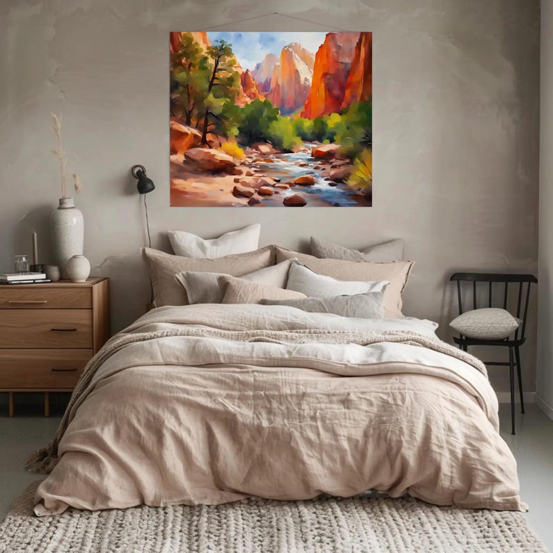 May include: A watercolor painting of a canyon landscape with a river, trees, and red rock formations. The artwork is displayed above a bed with beige bedding and pillows. The room has a neutral color palette.