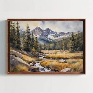May include: A watercolour painting depicting a mountain landscape with a stream meandering through a meadow. The artwork showcases tall pine trees, rocky areas, and snow-covered mountains in the background. The painting is presented in a wooden frame.