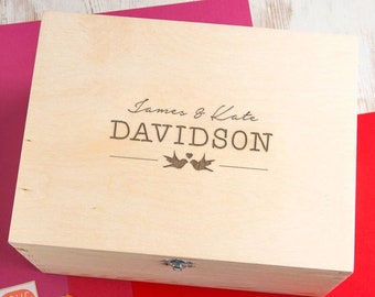 May include: A wooden keepsake box with a hinged lid and a latch. The box is engraved with the text "James & Kate DAVIDSON" and two birds with a heart above them.