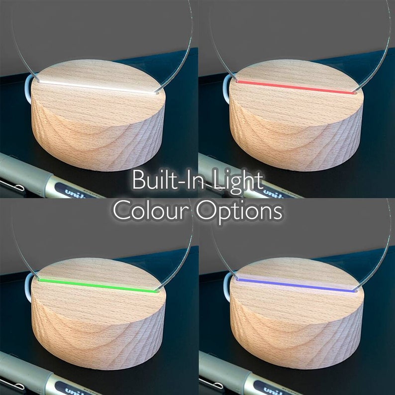 May include: A wooden base with a built-in light, showcasing color options: white, red, green, and blue. The light is integrated into a clear, curved acrylic element. The text "Built-In Light Colour Options" is displayed.