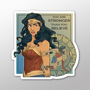 May include: A sticker featuring a colorful illustration of Wonder Woman with the text "You are stronger than you believe".