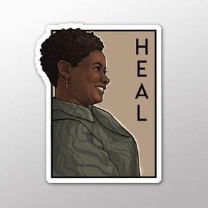 May include: A sticker featuring a portrait of a woman with short, dark hair. She is wearing a green and brown patterned shirt and smiling. The word "HEAL" is written vertically in black letters on the right side of the sticker.