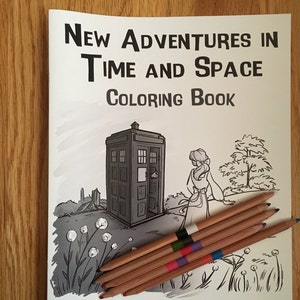 May include: A coloring book titled "New Adventures in Time and Space" with a black and white illustration of a police box and a woman. Seven colored pencils rest on the book. The author's name, Karen Hallion, is at the bottom.