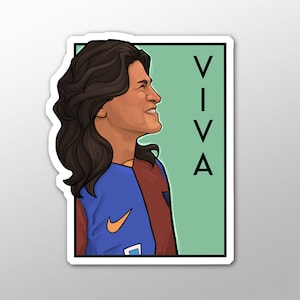 May include: A sticker featuring a cartoon illustration of a person with long brown hair wearing a blue and maroon jersey with a white Nike swoosh. The background is green with the word "VIVA" in black letters.