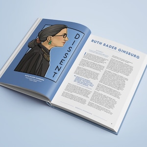 May include: An open book with a black and white illustration of Ruth Bader Ginsburg, a Supreme Court Justice, on the left page. The right page has text about her dissent and the title "Ruth Bader Ginsburg".