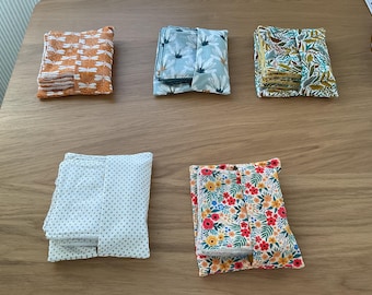 May include: Five different fabric pouches with various patterns. The pouches are made of cotton and have a simple design. The patterns include floral, geometric, and abstract designs.