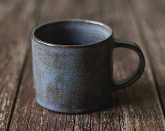 Handmade wheelthrown pottery rustic earthy mug with handle and grey blue and brown semi-matte glaze