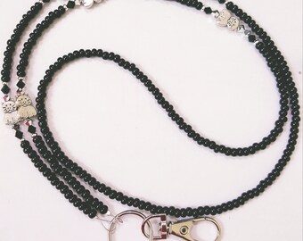 May include: Black beaded lanyard with silver cat charms and a silver swivel clasp.