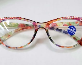 May include: Floral print reading glasses with pink rhinestones on the temples and a blue sticker that says " +1.50  Reading Glasses".