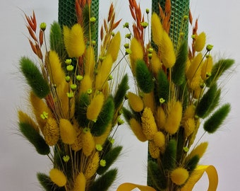 Candles made of natural wax for weddings or baptisms, decorated with dried natural flowers, green and yellow