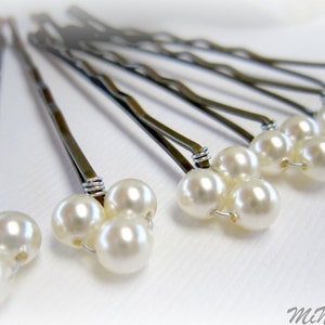 May include: Set of six silver hair pins with three white pearl beads on each pin.