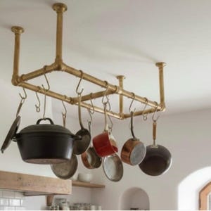 May include: A trio of ceramic mugs with a speckled, matte finish in cream, light grey, and dark grey. Each mug features a minimalist design and a rounded handle. Suitable for tea or coffee, these mugs offer a simple aesthetic.