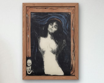 May include: A framed black and white lithograph print of a woman with long dark hair and a blue shawl. The woman is depicted with a sad expression and a small figure of a child is in the lower left corner of the image.
