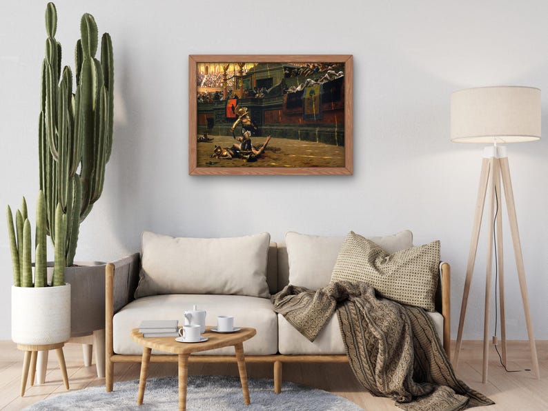 May include: A framed painting depicting a scene from a Roman gladiatorial contest. The painting shows a gladiator in a red tunic fighting a wild animal in a sand arena. The scene is set in a large amphitheatre with spectators in the background.
