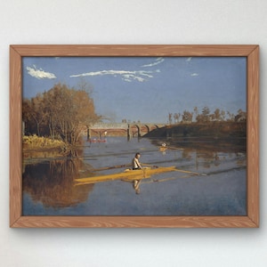 May include: A framed painting depicting a man rowing a yellow boat on a river. The river is surrounded by trees and a bridge is visible in the background. The sky is blue with white clouds.