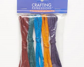May include: A package of six spools of colorful twine, each spool is a different color: purple, orange, blue, green, brown, and red. The twine is labeled "Crafting Expressions".