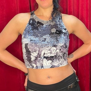 May include: A black and white crop top with a geometric pattern. The top is made of a soft, velvety material.